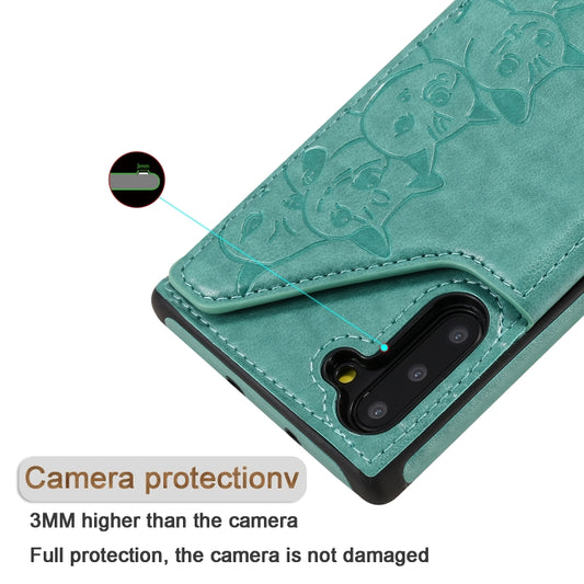 Galaxy phone case with decorative cat embossing, card holders, and stand functionality closeup