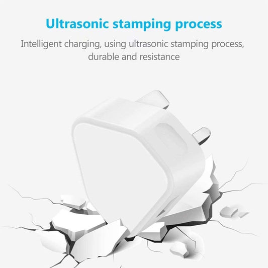Compact white USB power adapter with safety certifications and UK plug prongs