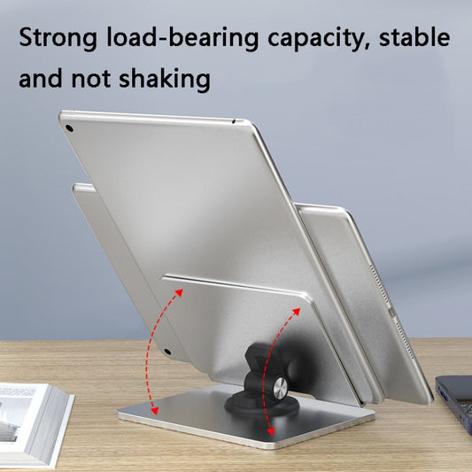 Compact folding tablet stand in use on office desk, holding iPad at ergonomic viewing angle