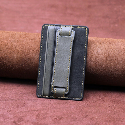 Adhesive phone wallet sleeve featuring pull strap attachment detail