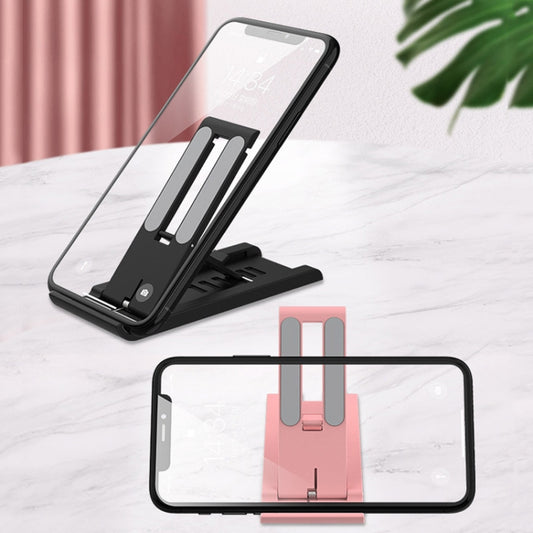 Laptop and phone holder setup demonstrating multi-device workspace organization