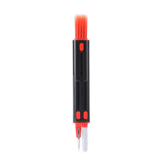Close-up of cleaning pen tip removing debris from earbud charging case