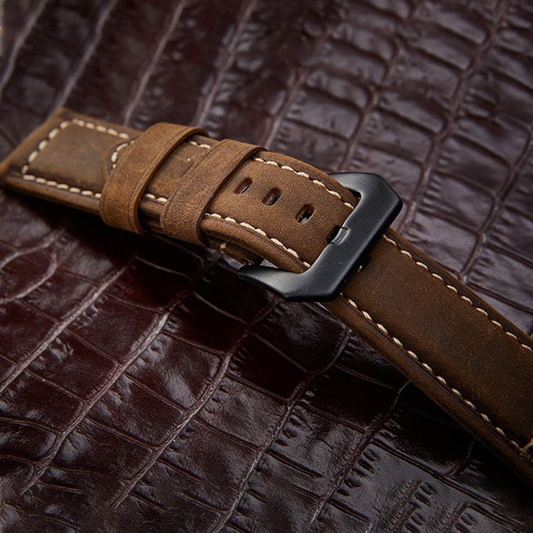 Close-up of frosted black buckle mechanism and leather weave pattern on 20mm band